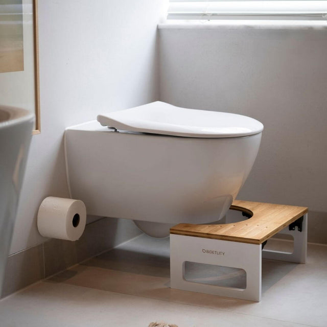 Discover the Bidetlity toilet stool - the stylish, ergonomic bathroom accessory for healthier bowel movements. Made from sustainable bamboo, it fits perfectly under your toilet and supports a natural, squatting posture.